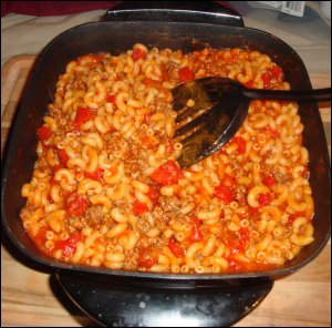 Preparation of beefaroni in a large truck.