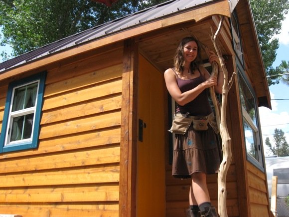 Ella in front of her Tiny Home