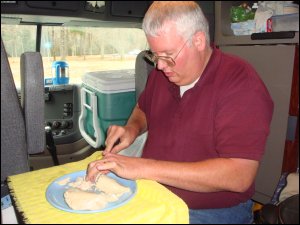 Meal preparation with ice chest in background.