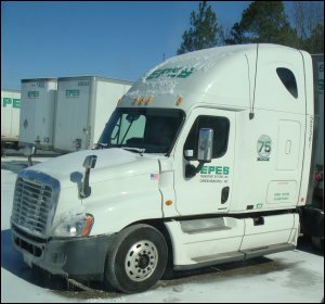 A truck parked during the winter.